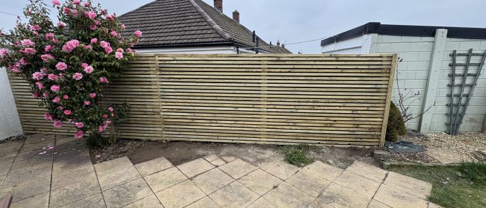Horizontal hit and miss fencing behind a slabbed patio