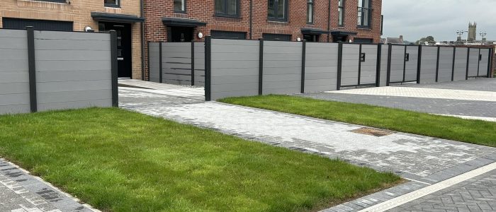 Grey horizontal composite fencing with matching driveway gates with contrasting black composite posts