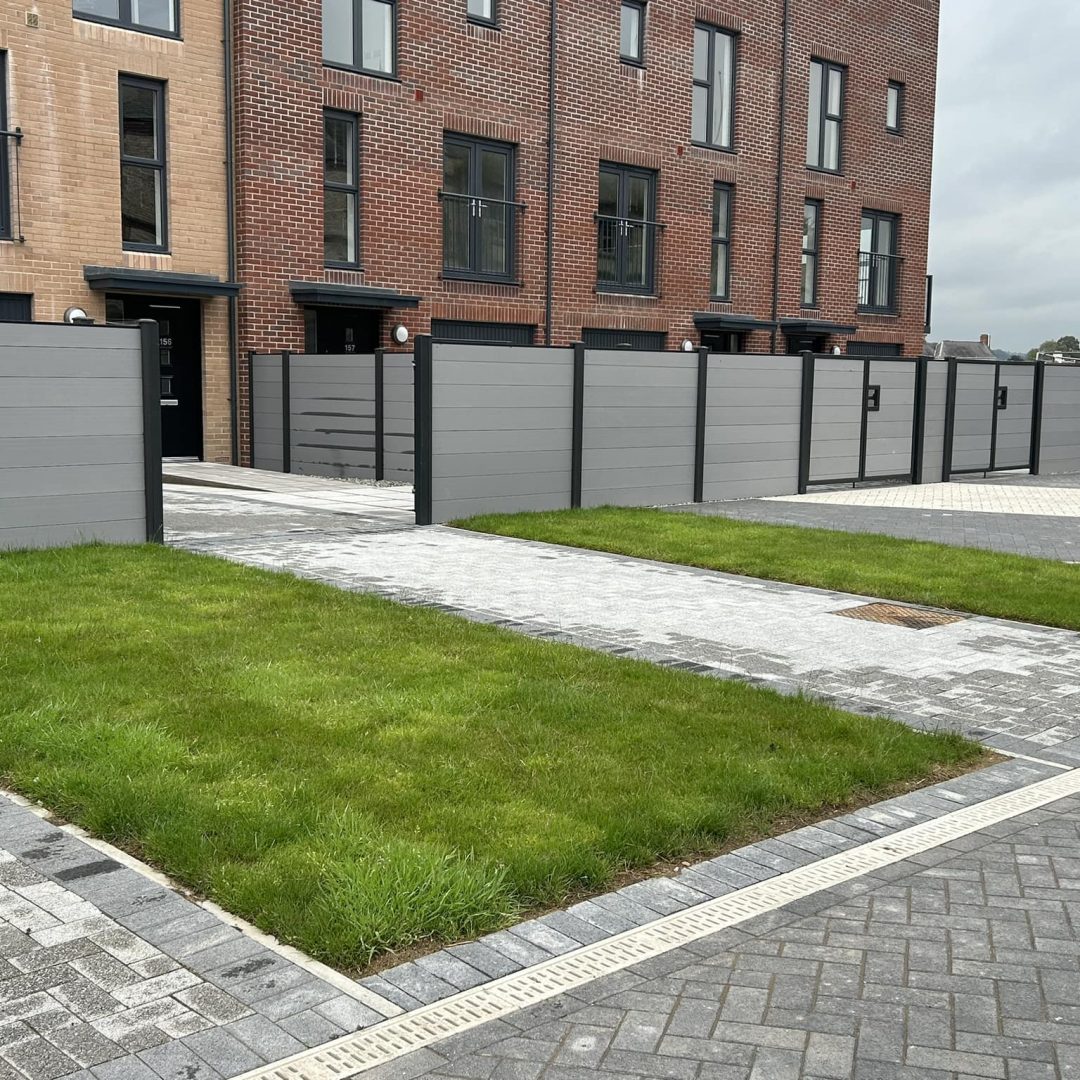 Grey horizontal composite fencing with matching driveway gates with contrasting black composite posts